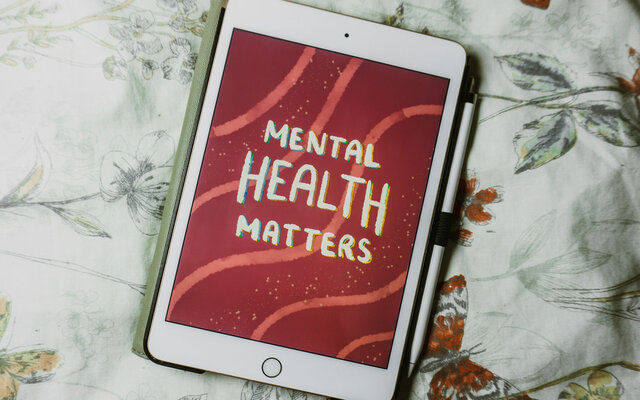 Tablet mit Schriftzug "Mental Health Matters" auf Bett